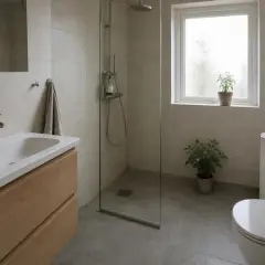 Modernt badrum med dusch, handfat och toalett. Tänk på renovera badrum pris för en liknande stil.